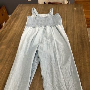 A 100% light denim jumpsuit size medium- only worn once.